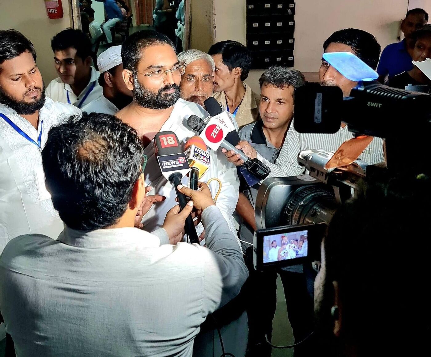 Yog Bhooshan Maharaj surrounded by national TV reporters from News18, Zee News and News World 4U